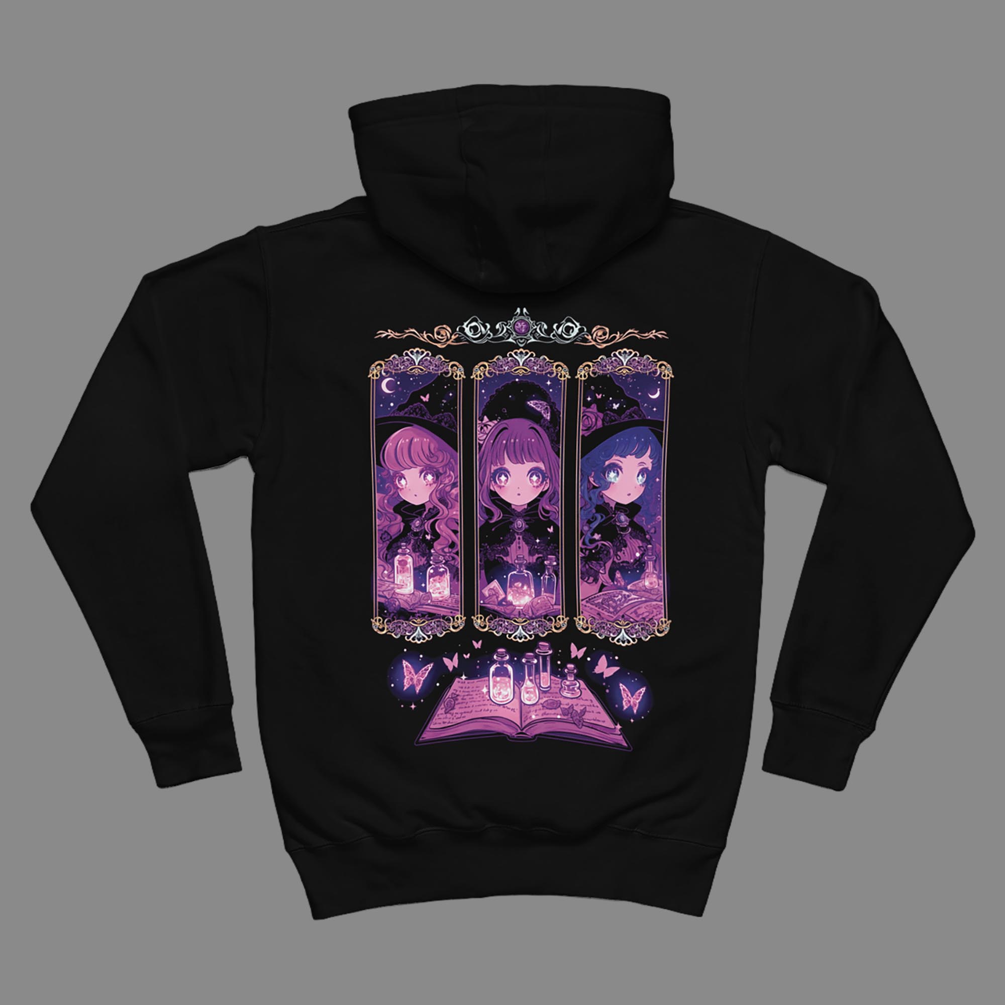 Flat lay of the black Coven Sisters Kawaii Witch Hoodie on a grey background, displaying the full purple triptych witch and open spellbook back design.